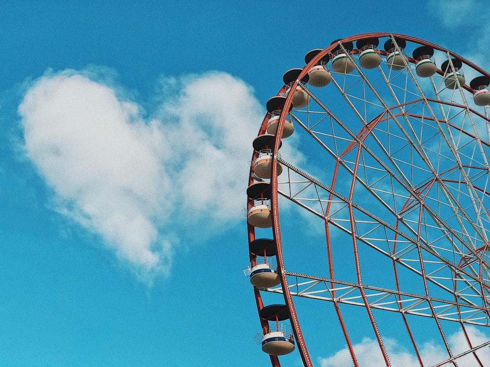 red and white ferris wheel under blue sky during daytime