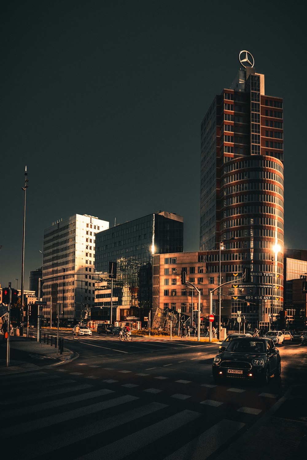 cars on road near high rise buildings during night time