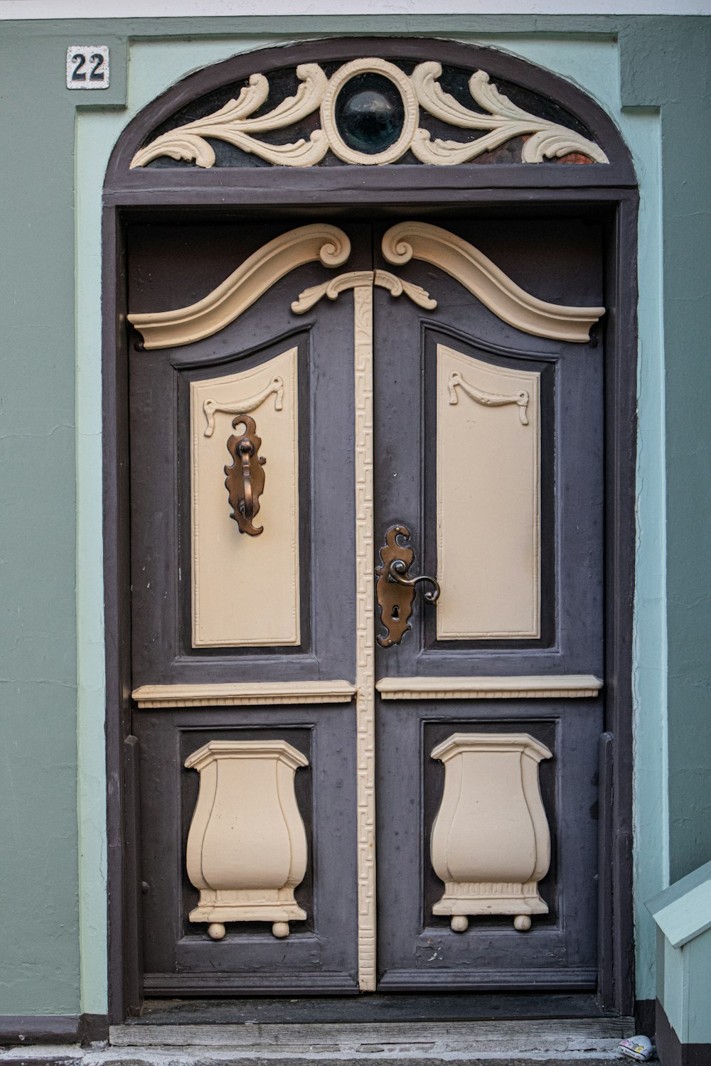 blue wooden door with brass door lever