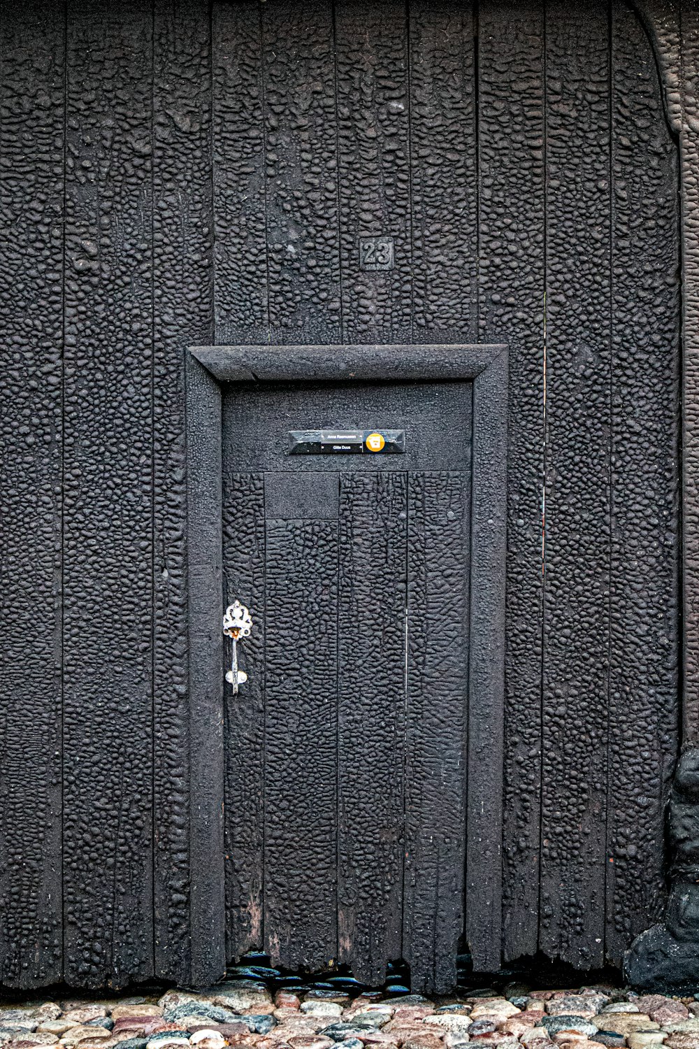 black wooden door with gold padlock