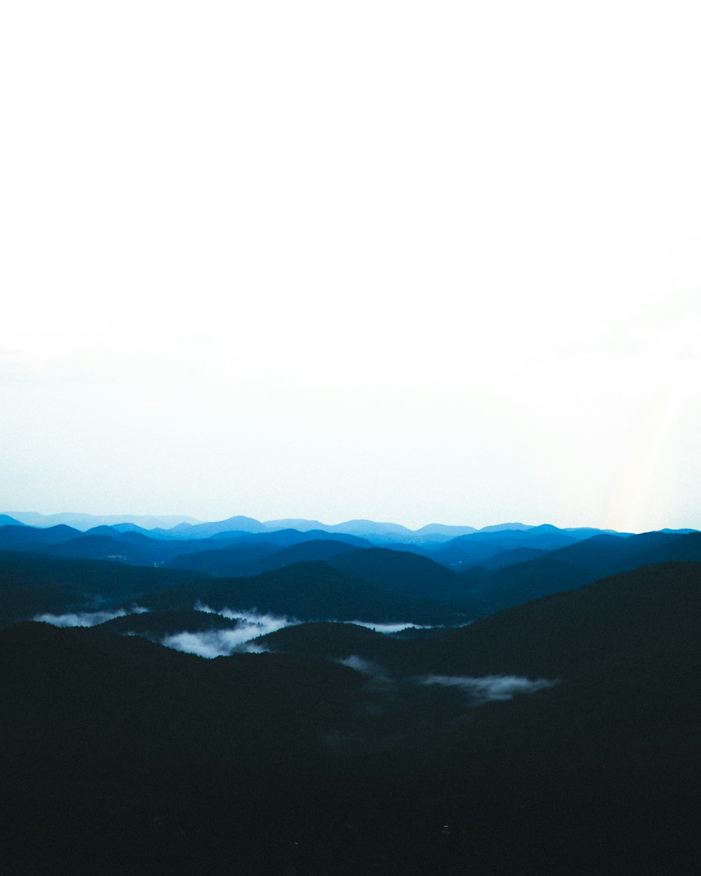 black mountains covered with fog