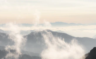 Serene landscape of a misty mountain range at dawn, symbolizing steady growth and long-term vision.