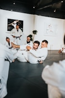man in white dress shirt sitting on floor
