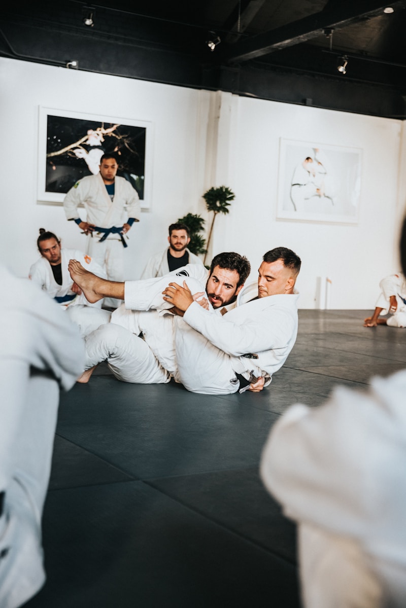 Two grapplers working leg entanglement techniques during a jiu-jitsu training session