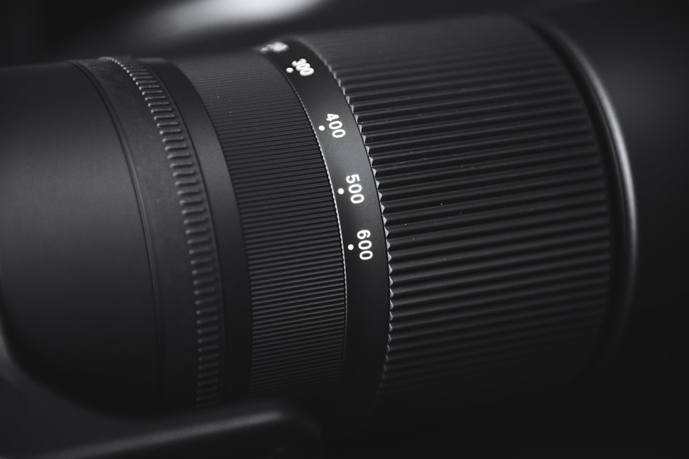 black camera lens on brown wooden table