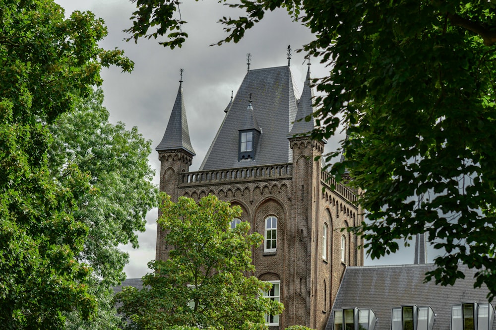 brown brick building near green trees during daytime