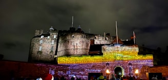 A group of volunteers restoring an ancient castle wall at sunset.