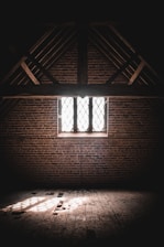 brown wooden window frame on brown brick wall