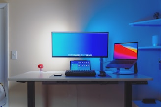 black flat screen computer monitor on white wooden desk