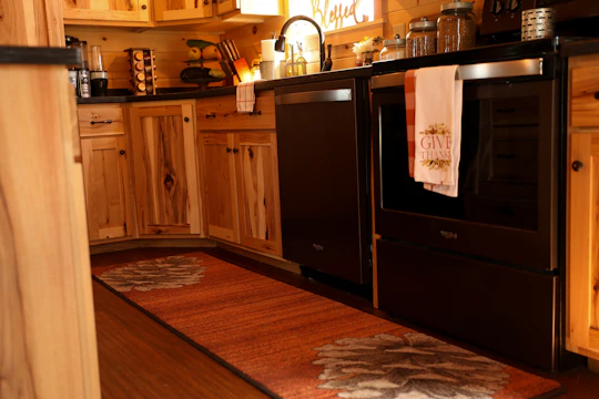 Modern kitchen with warm wooden cabinets and sleek countertops in a cozy home.