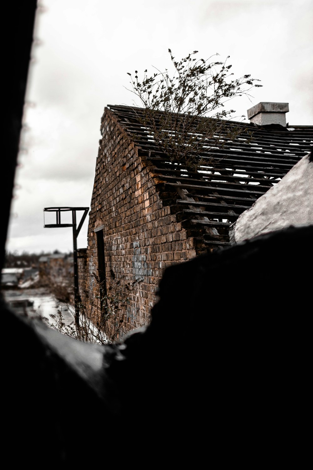 brown brick wall under cloudy sky during daytime