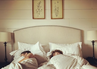 2 children lying on bed