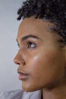 A close-up portrait of a person with natural light highlighting facial features.