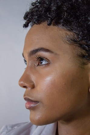A close-up portrait of a person with natural light highlighting facial features.