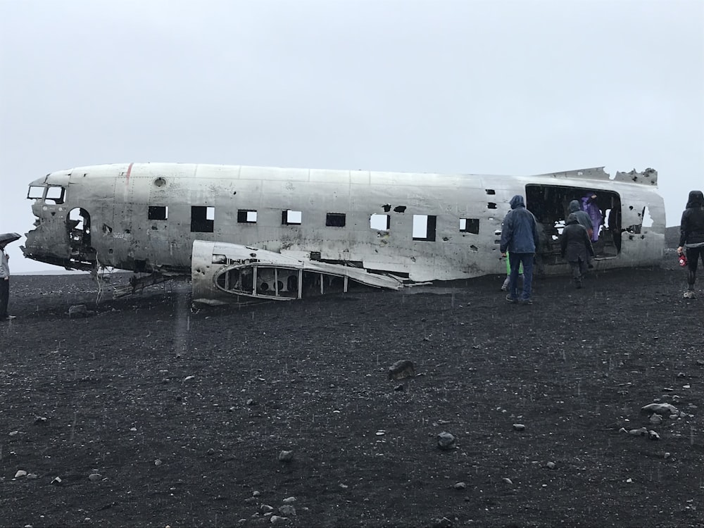 people standing near white airplane during daytime