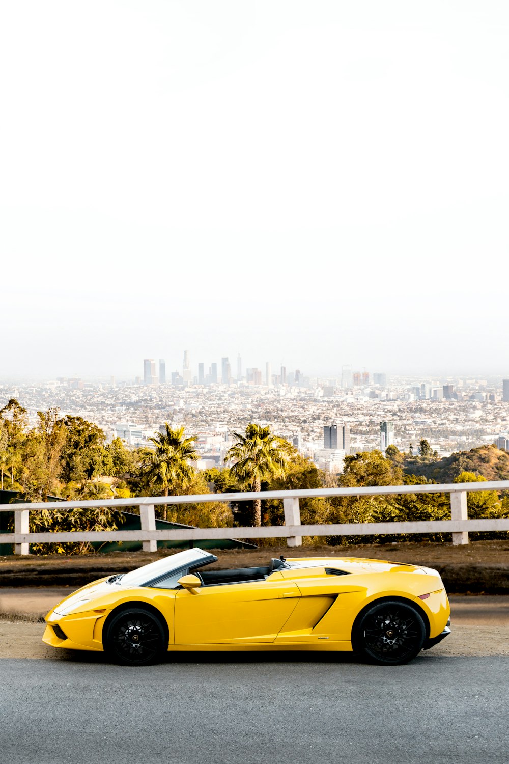 yellow ferrari coupe parked on a beach