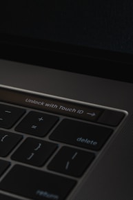 A close-up of hands typing on a laptop with a digital lock icon overlay.