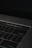 A close-up of a hand hovering over an 18+ age verification button on a laptop screen.