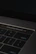 A close-up of a hand hovering over an 18+ age verification button on a laptop screen.