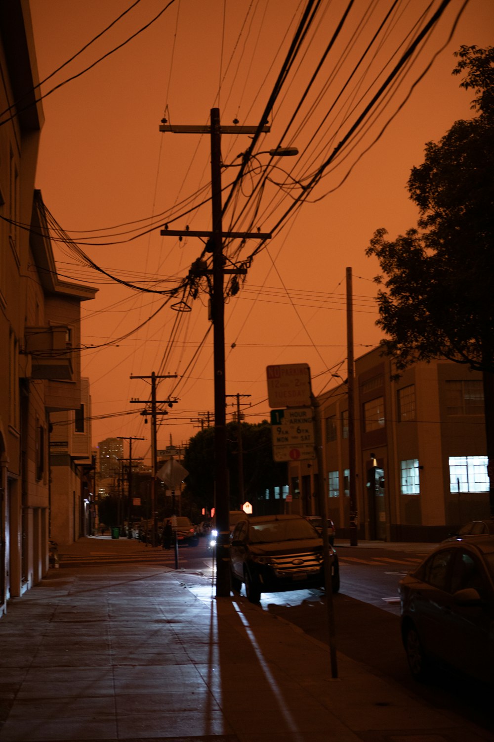 black car on road near building during sunset