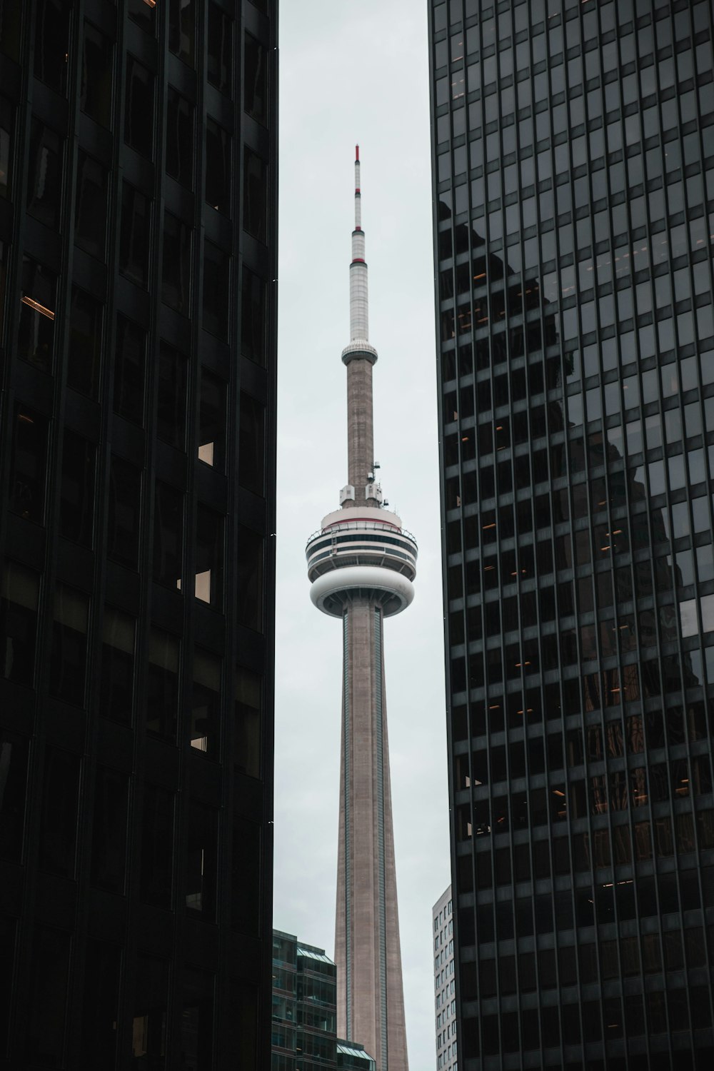 white and black tower in the city during daytime