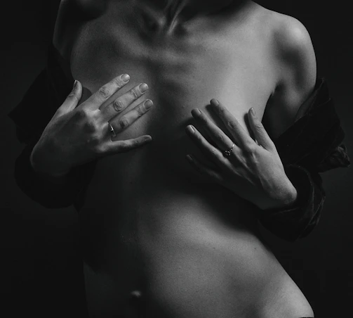 Close-up of hands performing chest compressions on an adult CPR mannequin, with focus on technique.