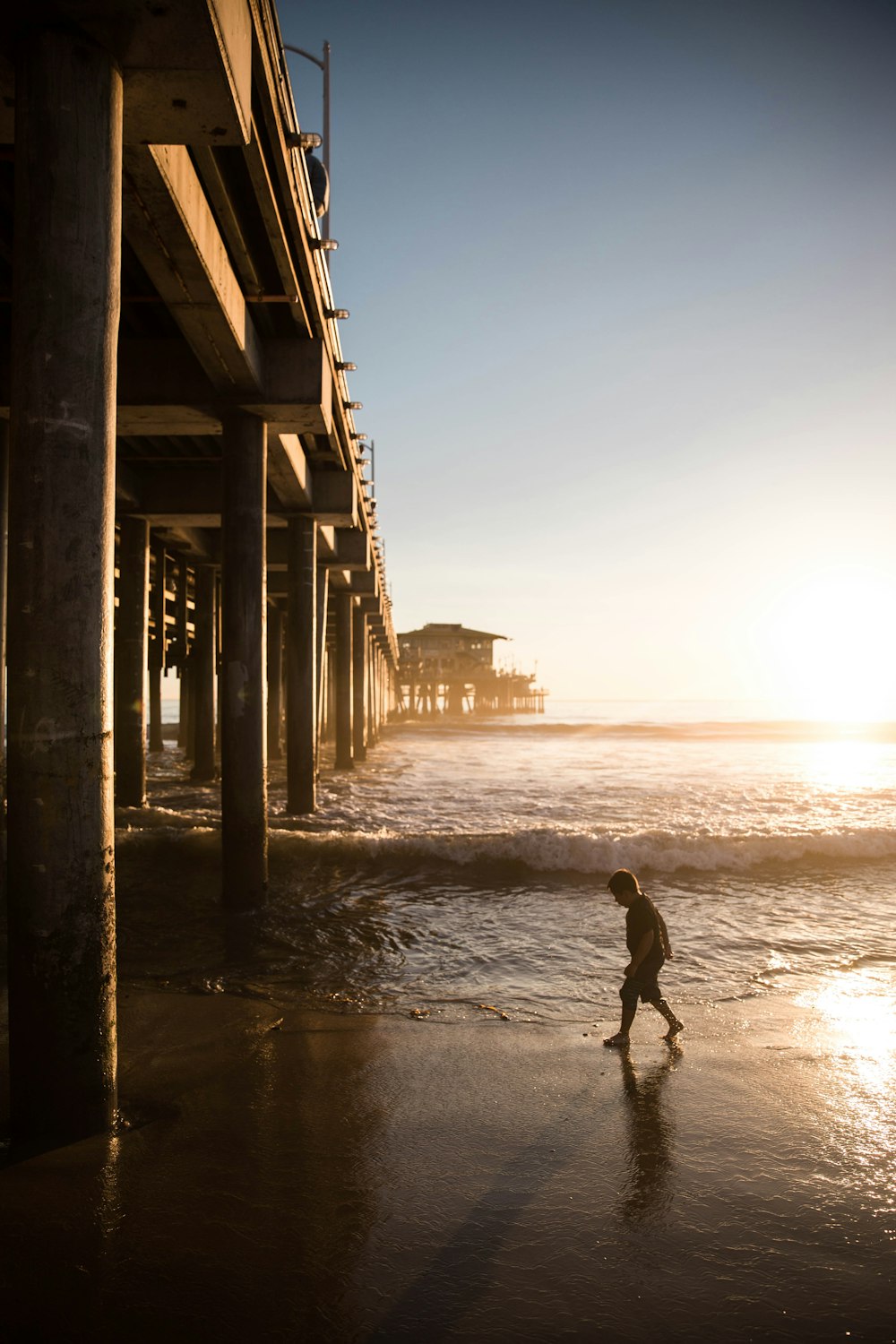 man walking on beach during daytime