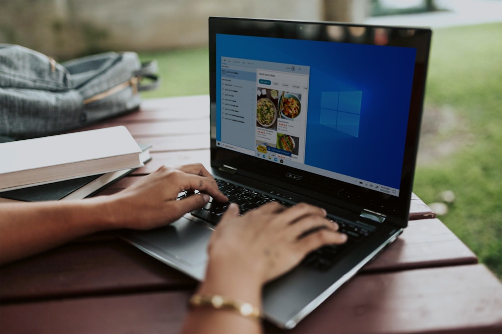 person using black laptop computer