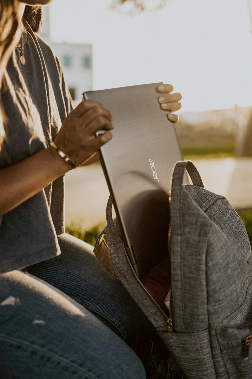 person in blue denim jeans holding white paper