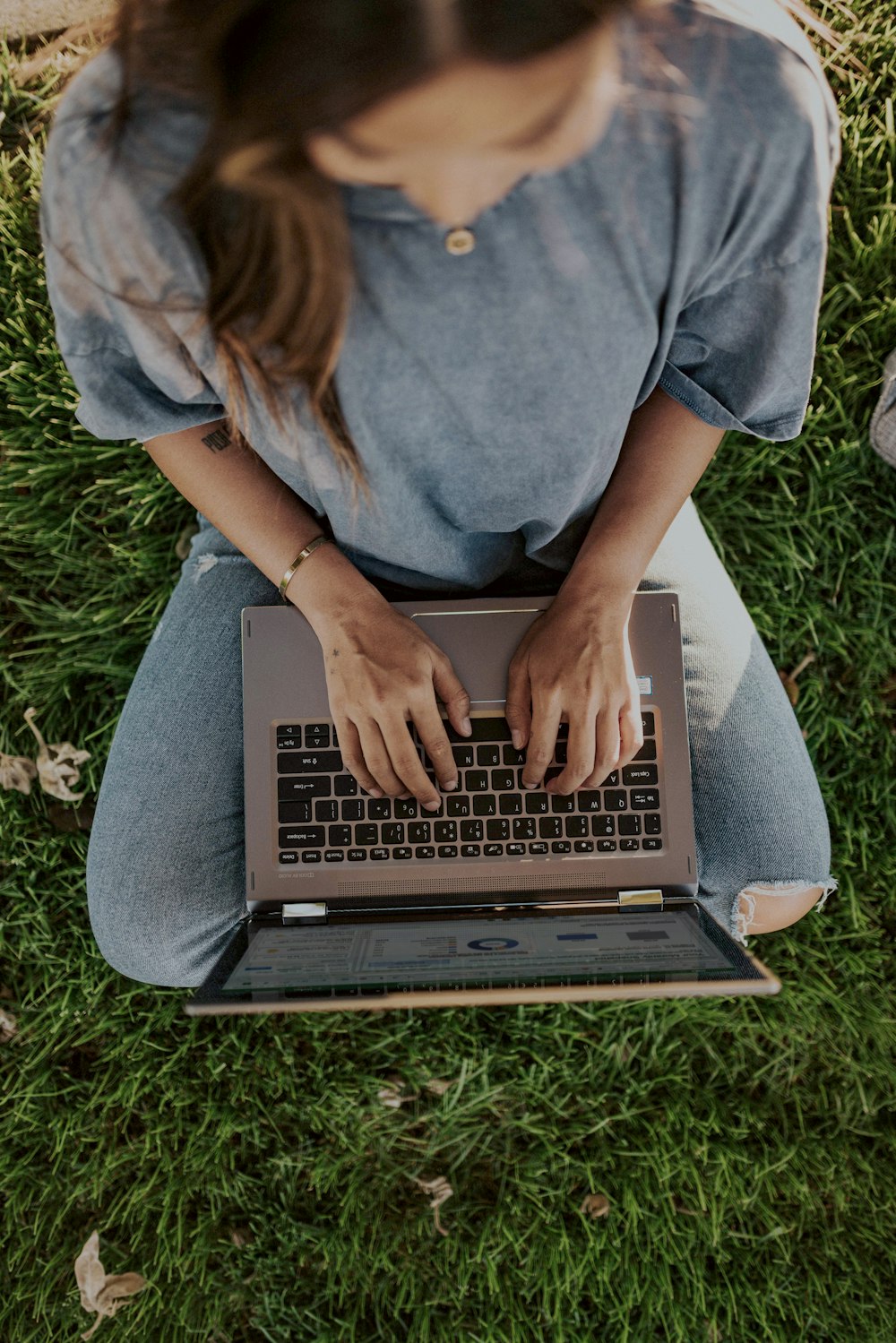 person in blue shirt using laptop