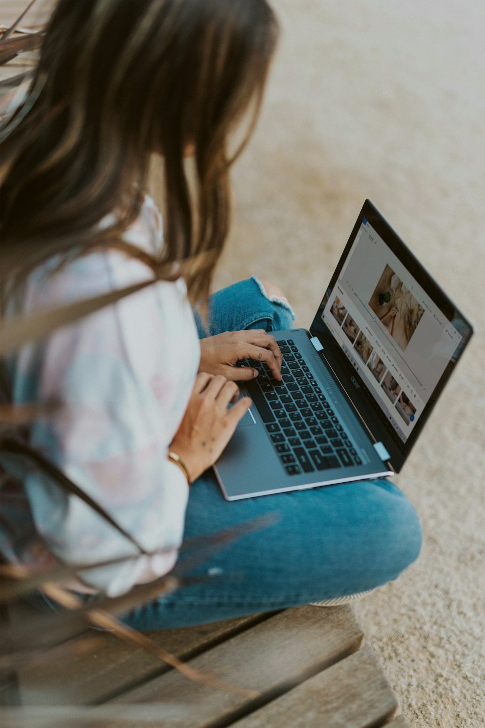 woman in white long sleeve shirt using laptop