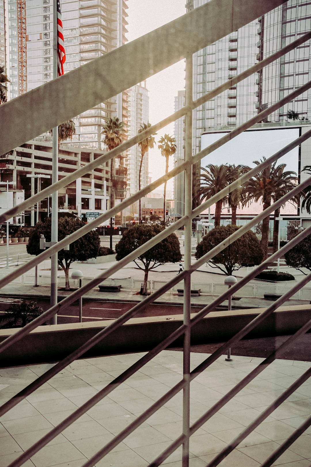 green palm trees near white concrete building during daytime