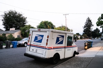 white and blue van on road during daytime