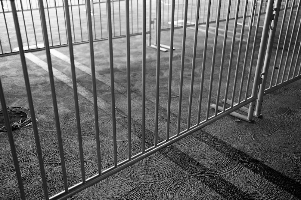 gray metal fence on gray textile