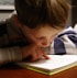 boy in gray and red hoodie reading book