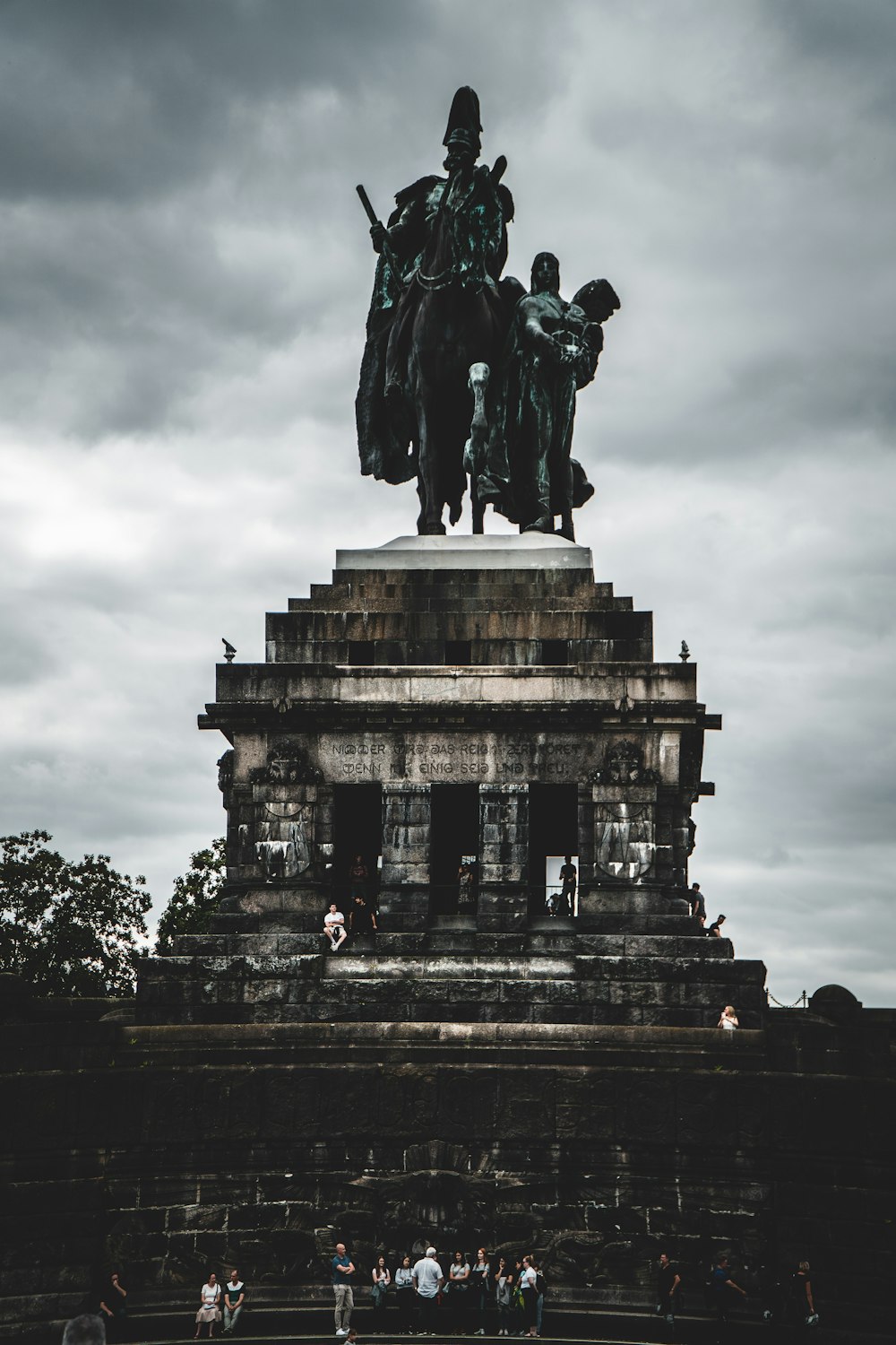 statue of man riding horse under cloudy sky during daytime