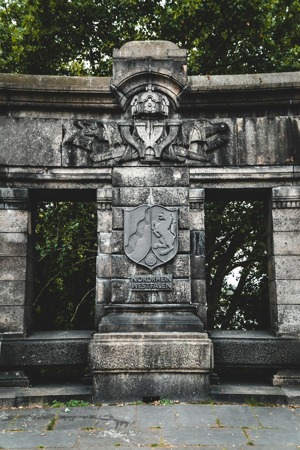 grey concrete cross on grey concrete post