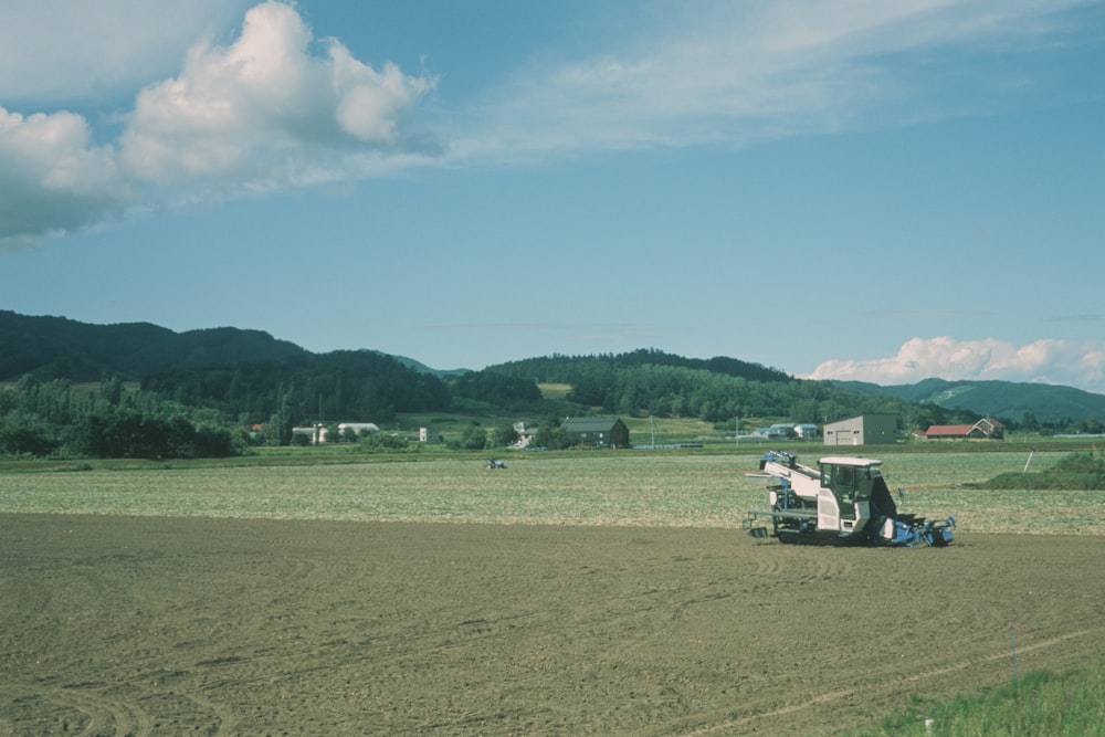 white and black truck on brown field under blue sky during daytime