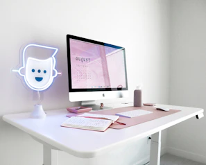 A bright, minimalist desk setup featuring a calendar and sticky notes highlighting free resources.