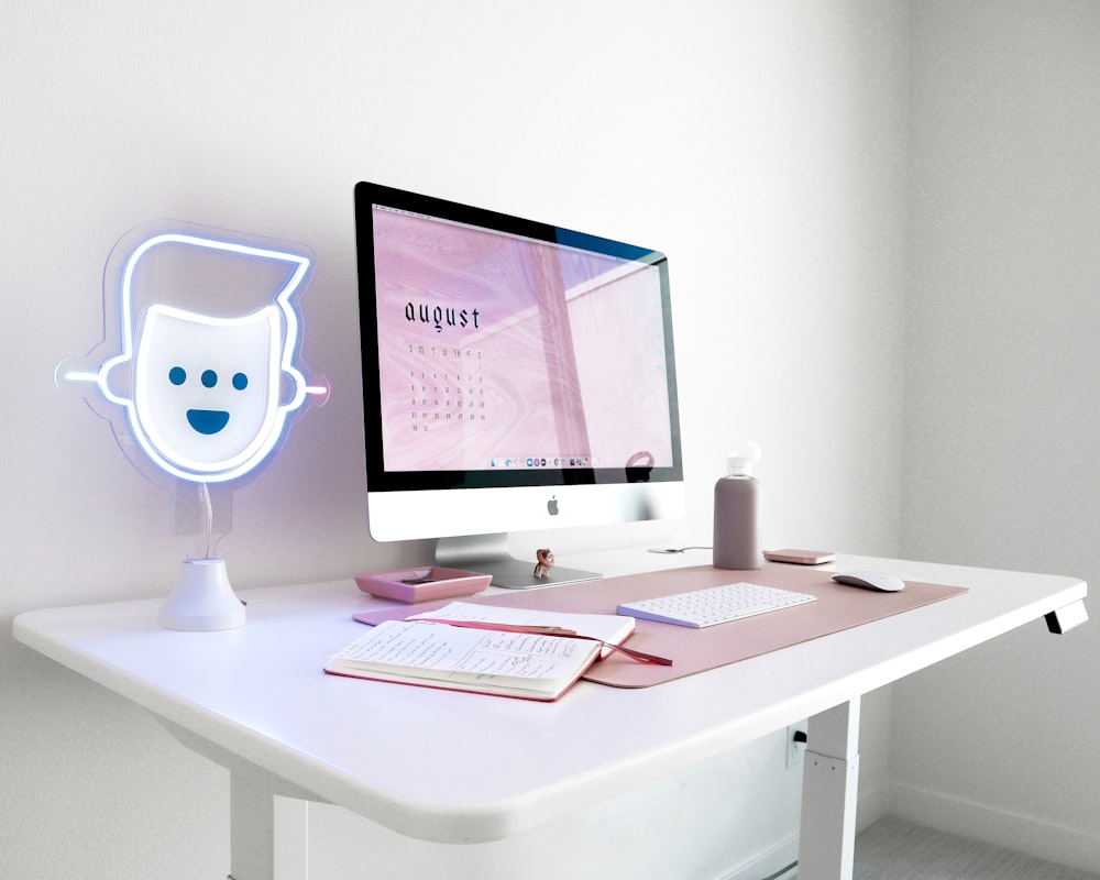 black flat screen computer monitor on white wooden desk