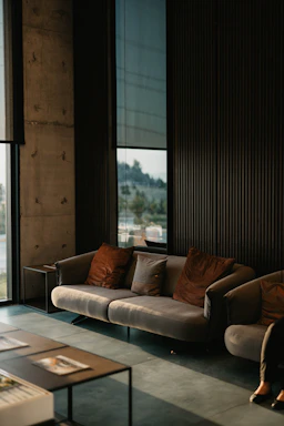 brown and white couch beside window