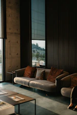 brown and white couch beside window