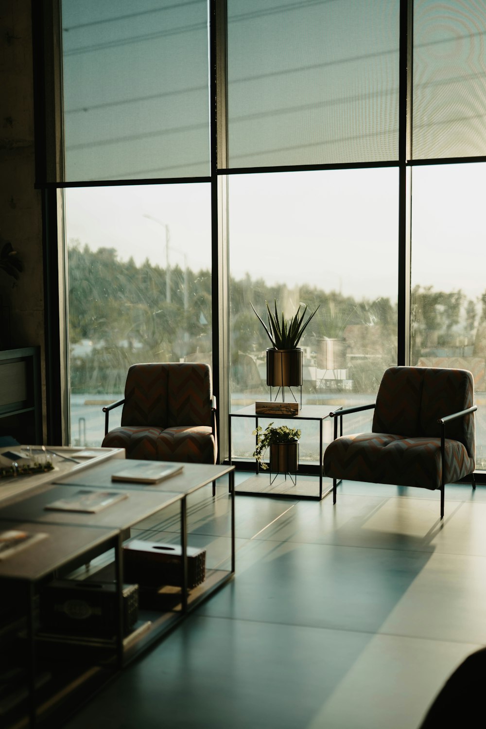 black and white sofa chair near glass window