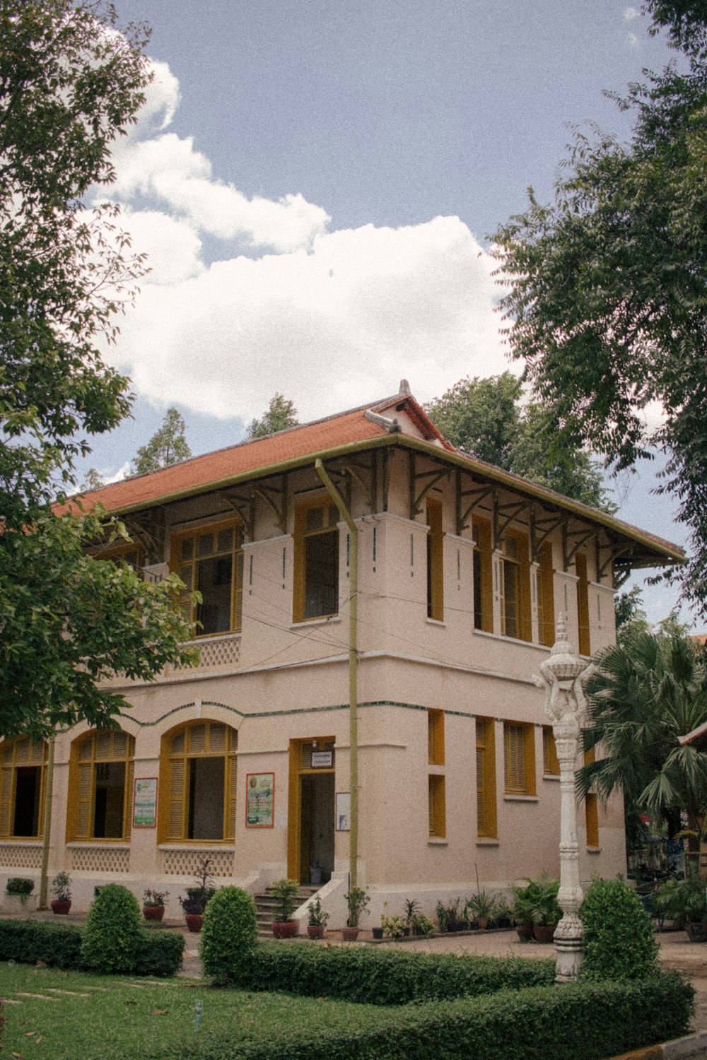 brown concrete building near green trees during daytime