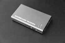 A compact, metallic, rectangular electronic device with the brand name NEBRA printed on the top. It features several ports on the side, including an HDMI port, and a couple of buttons on the top surface.