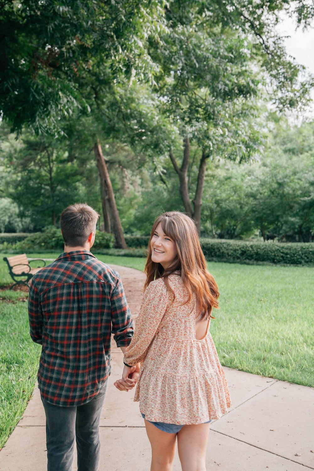 man and woman standing on pathway during daytime