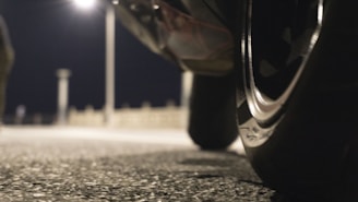 A friendly roadside technician assisting a customer with tire service at dusk.
