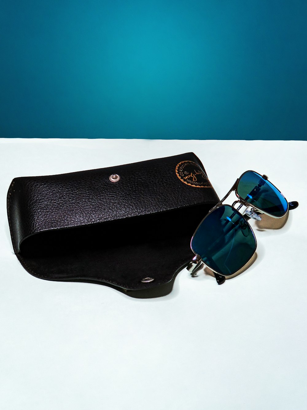 black sunglasses on black leather pouch