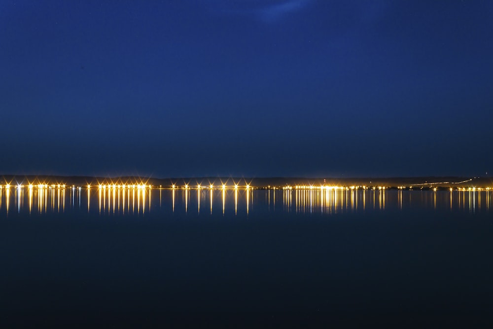 body of water under blue sky during night time