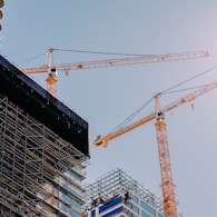 yellow crane near building during daytime